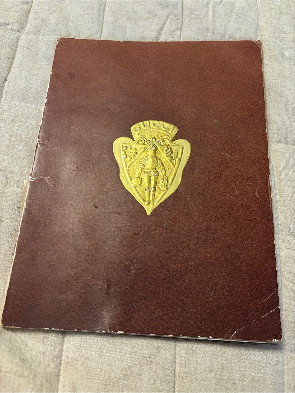 Gucci 1981 catalog with embossed gold cover look book